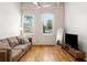 Bright living room featuring hardwood floors, high ceilings, and large windows with natural light at 210 Walker Sw St # 3, Atlanta, GA 30313
