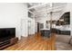 Bright open-concept living room with modern kitchen, island, stainless appliances, and hardwood floors at 210 Walker Sw St # 3, Atlanta, GA 30313