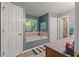 Well-lit bathroom featuring a bathtub, gray walls, and tile floors at 345 Jesse Martin Trl, Canton, GA 30115