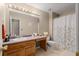 Inviting bathroom featuring neutral colors, vanity, and shower with floral shower curtain at 345 Jesse Martin Trl, Canton, GA 30115