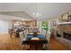 Open dining area with stone fireplace seamlessly flowing into a well-equipped kitchen at 345 Jesse Martin Trl, Canton, GA 30115