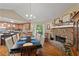 Inviting dining area showcasing a stone fireplace, hardwood floors, and open access to the kitchen at 345 Jesse Martin Trl, Canton, GA 30115