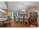 Charming dining room with a stone fireplace, hardwood floors, and an adjacent kitchen at 345 Jesse Martin Trl, Canton, GA 30115
