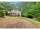Home with covered porches, a metal roof and surrounded by lush, green trees and vegetation at 345 Jesse Martin Trl, Canton, GA 30115