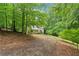 Charming home with a wooded lot and a long driveway leading to the front porch at 345 Jesse Martin Trl, Canton, GA 30115