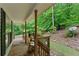 Inviting covered porch, perfect for relaxing and enjoying the peaceful wooded surroundings at 345 Jesse Martin Trl, Canton, GA 30115