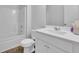A bright bathroom features a white vanity, toilet, and bathtub with shower at 3455 Jasmine Sw Way, Atlanta, GA 30331