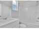 Bright bathroom with a window, tub shower combo, and a single sink vanity at 3455 Jasmine Sw Way, Atlanta, GA 30331