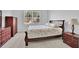 Traditional primary bedroom with neutral walls and carpet, dark furniture, and natural light at 3455 Jasmine Sw Way, Atlanta, GA 30331