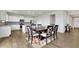 Elegant dining area showcasing wood floors and a sophisticated dark wood table set, adjacent to a well-appointed kitchen at 3455 Jasmine Sw Way, Atlanta, GA 30331