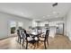 Bright dining area featuring hardwood floors, a modern table set, and an open layout to the kitchen at 3455 Jasmine Sw Way, Atlanta, GA 30331