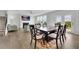 Open-concept dining area featuring a table, chairs, hardwood flooring, and doors to the outside at 3455 Jasmine Sw Way, Atlanta, GA 30331