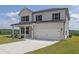 Two-story home with attached two car garage, green lawn and professional landscaping at 3455 Jasmine Sw Way, Atlanta, GA 30331