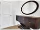 Elegant foyer with a decorative console table, oval mirror, and neutral wall color at 3455 Jasmine Sw Way, Atlanta, GA 30331