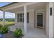 Inviting front porch with white columns, black front door, and manicured landscaping at 3455 Jasmine Sw Way, Atlanta, GA 30331