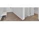 Bright hallway with hardwood floors, a white storage bench, and a white door at 3455 Jasmine Sw Way, Atlanta, GA 30331