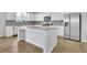 Modern kitchen boasts white cabinets, granite countertops, stainless steel appliances, and a spacious island at 3455 Jasmine Sw Way, Atlanta, GA 30331