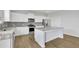 Bright kitchen features stainless steel appliances, a large island, granite countertops, and ample white cabinetry at 3455 Jasmine Sw Way, Atlanta, GA 30331
