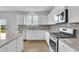 Well-lit kitchen showcasing granite countertops, stainless steel appliances, and white cabinets at 3455 Jasmine Sw Way, Atlanta, GA 30331