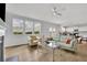 An open-concept living room with a kitchen, fireplace, dining area, and hardwood floors at 3455 Jasmine Sw Way, Atlanta, GA 30331