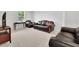 Spacious living room area with tan carpet, dark sofas, and a window at 3455 Jasmine Sw Way, Atlanta, GA 30331