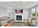 Inviting living room with a fireplace, plush sofas, a ceiling fan, and scenic windows at 3455 Jasmine Sw Way, Atlanta, GA 30331