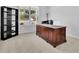 Well-lit home office featuring a wooden desk, built-in shelving, and a view to the outside at 3455 Jasmine Sw Way, Atlanta, GA 30331