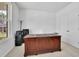 Bright home office with a wooden desk, white walls, large windows, and closet at 3455 Jasmine Sw Way, Atlanta, GA 30331