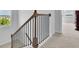 Staircase with light carpeted steps and dark metal railing on a wood banister at 3455 Jasmine Sw Way, Atlanta, GA 30331