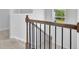 The upstairs landing has light colored carpet and dark metal railing on a wood banister at 3455 Jasmine Sw Way, Atlanta, GA 30331
