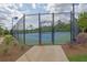 View of a community tennis court with well-maintained surface and secure fencing at 3455 Jasmine Sw Way, Atlanta, GA 30331