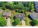Bird's-eye view of the house surrounded by lush greenery, showcasing curb appeal and neighborhood at 3975 Silverthorn Trce, Cumming, GA 30028