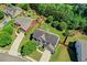 Aerial view of a lovely home showcasing its landscaped yard, mature trees and proximity to neighborhood at 3975 Silverthorn Trce, Cumming, GA 30028