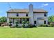 Expansive backyard featuring patio, large lawn, manicured shrubbery and two-story home at 3975 Silverthorn Trce, Cumming, GA 30028