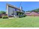 Spacious backyard featuring a well-maintained lawn and a screened-in porch, perfect for outdoor enjoyment at 3975 Silverthorn Trce, Cumming, GA 30028