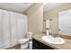 Bathroom with sink and vanity, white shower curtain, toilet, and modern hardware at 3975 Silverthorn Trce, Cumming, GA 30028
