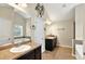 Spacious bathroom with double sinks, large mirrors, and a soaking tub with window views at 3975 Silverthorn Trce, Cumming, GA 30028