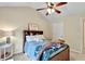 Bedroom featuring sloped ceiling, bed with stuffed animals, window, and side table at 3975 Silverthorn Trce, Cumming, GA 30028