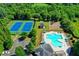 Aerial shot of a community pool area with tennis courts, playground, and a sparkling pool at 3975 Silverthorn Trce, Cumming, GA 30028