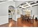 Formal dining room with coffered ceilings, wainscoting, hardwood floors and elegant lighting fixture at 3975 Silverthorn Trce, Cumming, GA 30028