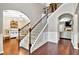 Elegant entryway with hardwood floors, an open staircase, and views into the living spaces at 3975 Silverthorn Trce, Cumming, GA 30028