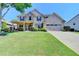 Charming two-story home with stone accents, a well-manicured lawn, and an attached two-car garage at 3975 Silverthorn Trce, Cumming, GA 30028