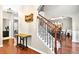 Elegant foyer showcasing staircase with carpet runner, wooden banister and adjacent dining room at 3975 Silverthorn Trce, Cumming, GA 30028