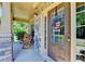 Inviting front porch with stone accents, wood rocking chairs, and a patriotic door decoration at 3975 Silverthorn Trce, Cumming, GA 30028