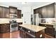 Stylish kitchen with stainless steel appliances, granite countertops, kitchen island, and dark cabinetry at 3975 Silverthorn Trce, Cumming, GA 30028