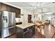 Spacious kitchen featuring a granite island, dark cabinetry, stainless steel appliances, and eat-in dining at 3975 Silverthorn Trce, Cumming, GA 30028