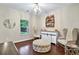 Bright room with hardwood floors and decoratively displayed liquor collection and comfortable seating near the window at 3975 Silverthorn Trce, Cumming, GA 30028