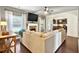 Cozy living room with fireplace, TV, large sectional and view into the kitchen with breakfast bar at 3975 Silverthorn Trce, Cumming, GA 30028