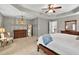 Main bedroom with chandelier lighting, accent chair, and wooden dressers providing an elegant retreat at 3975 Silverthorn Trce, Cumming, GA 30028
