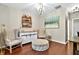 Cozy sitting room featuring hardwood floors, neutral decor, and stylish accent furniture at 3975 Silverthorn Trce, Cumming, GA 30028